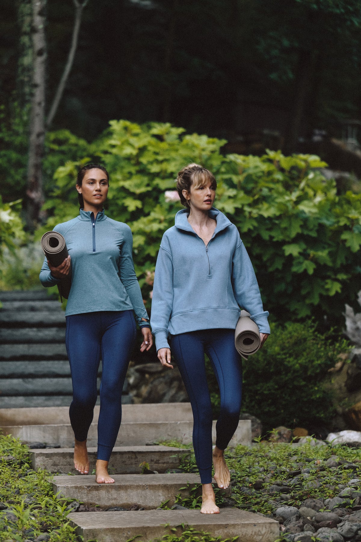 Woman running in a teal rain jacket