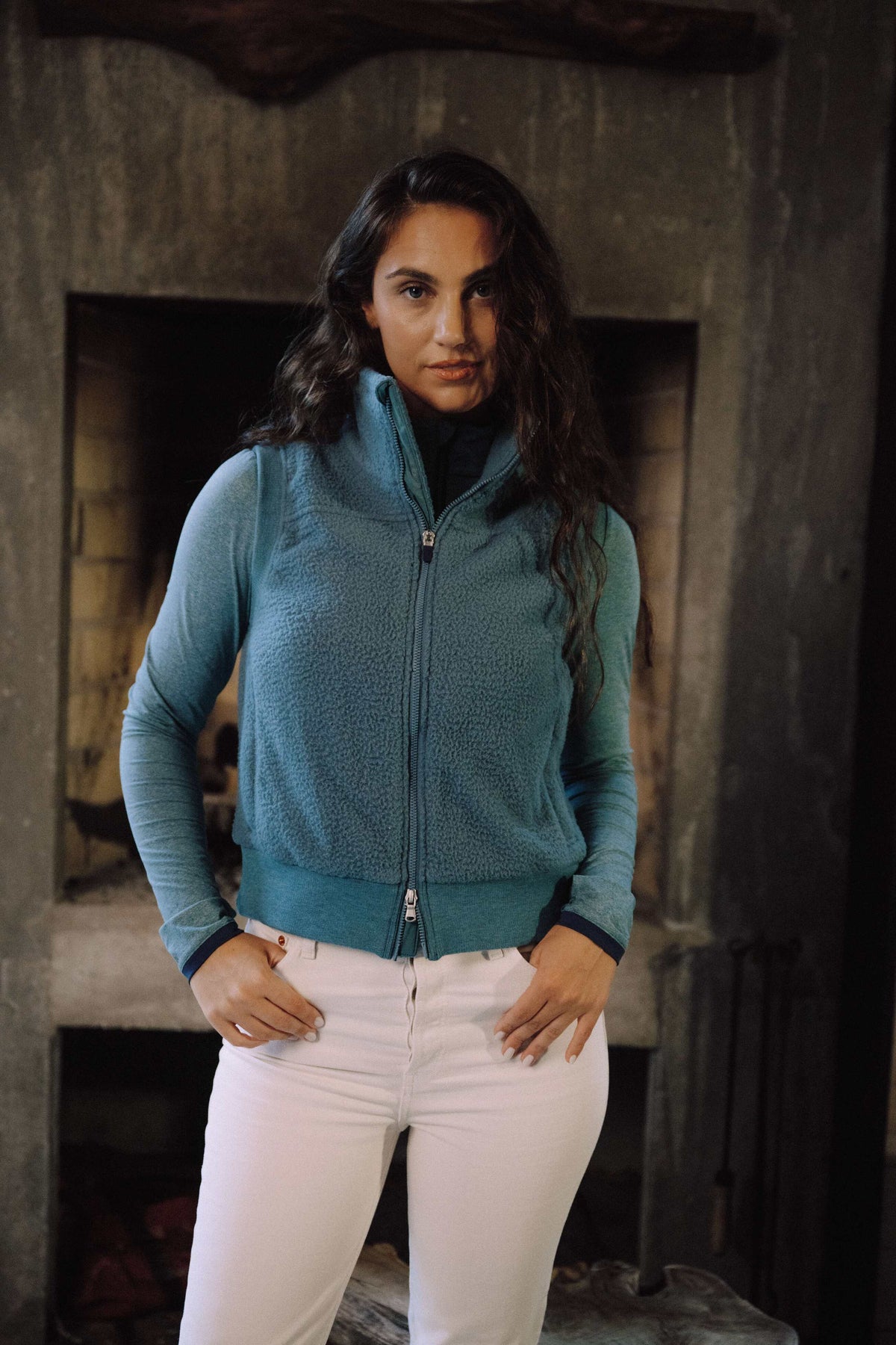 Woman in a grey sherpa jacket and sunglasses