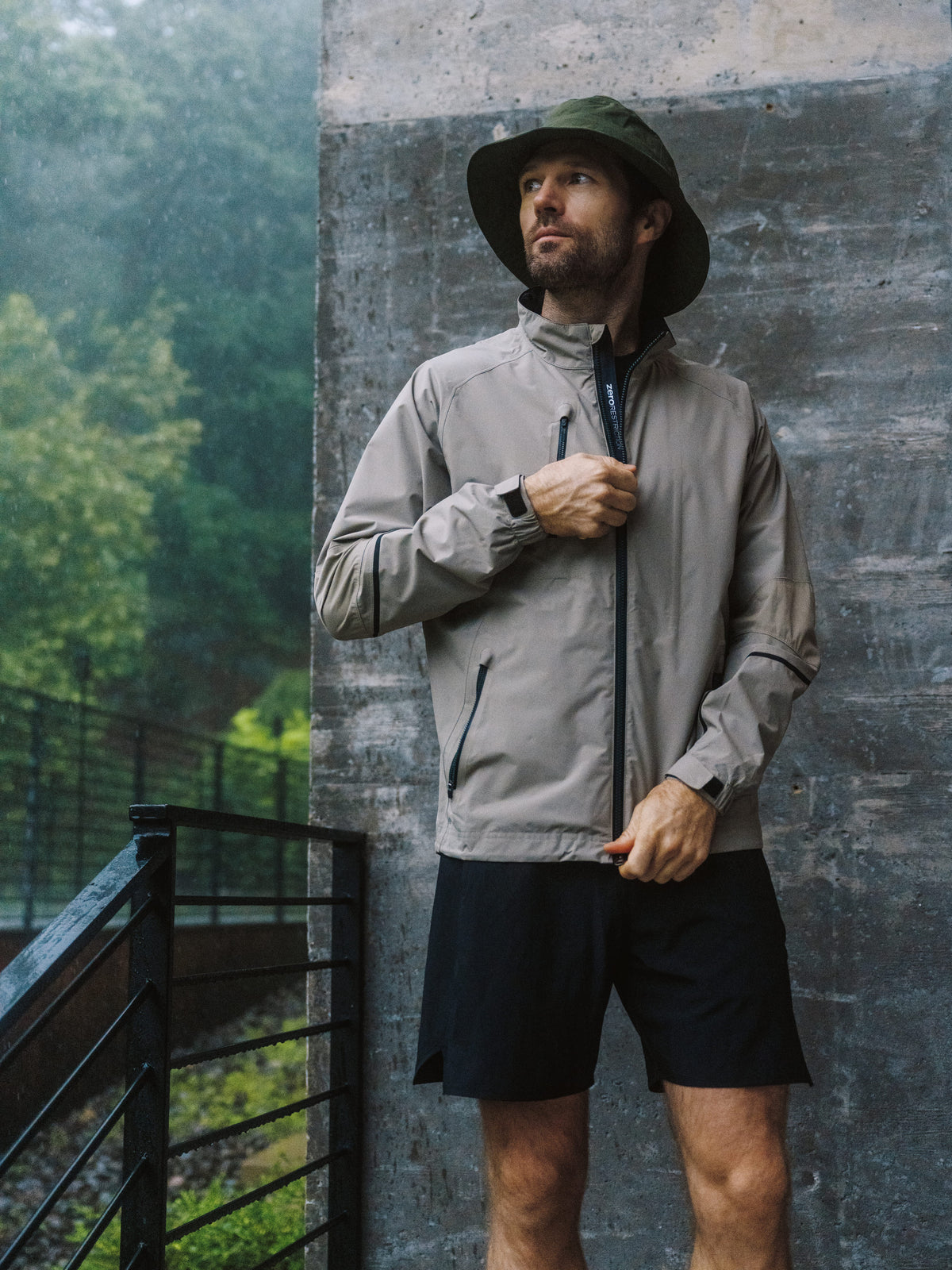 Man in a hooded rain jacket in the forest